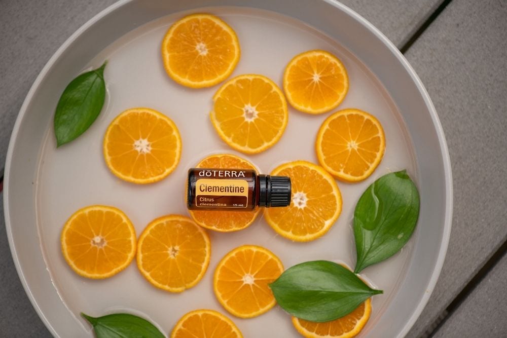 a doterra oil bottle on a plate of orrange