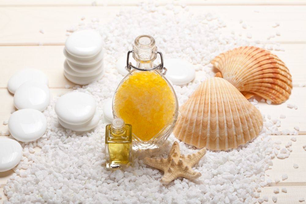 oil bottle with small rocks, salts, some shells