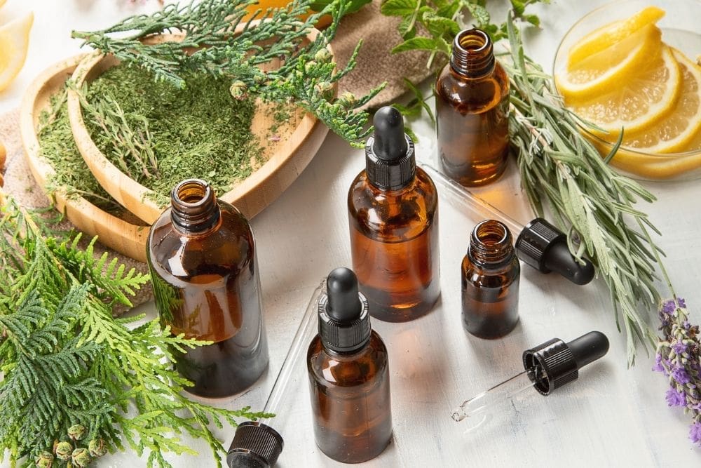 five essential oil bottles with orange, lavender
