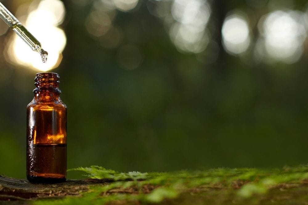 Essential oil bottle on wood
