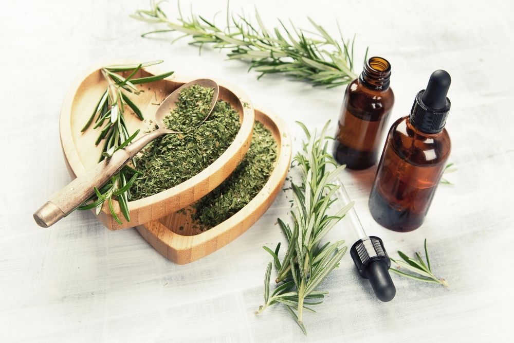 two essential oil bottles with leaves