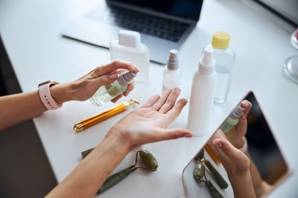 a lady is using bottles of essential oils