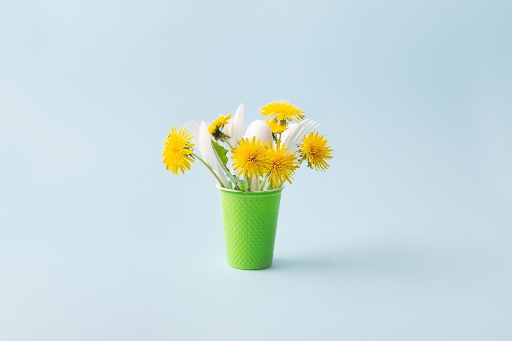 PET Plastic can with flowers, forks and spoons in it