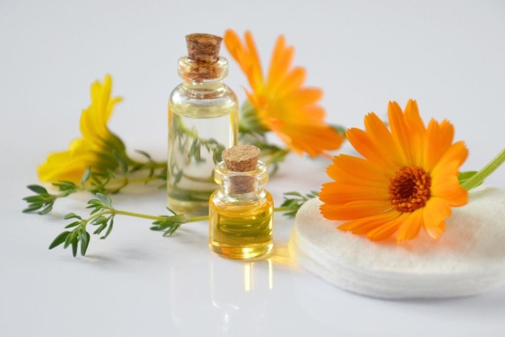 two essential oil bottles with flowers